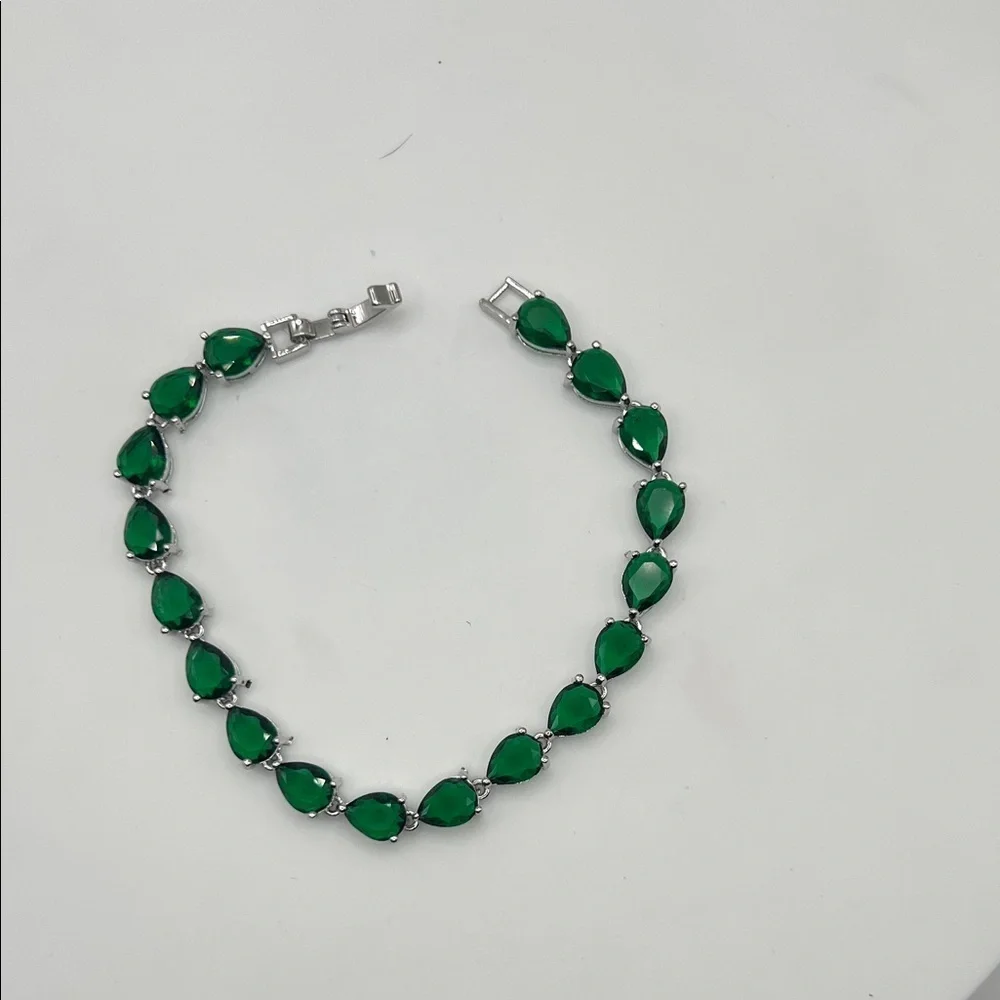 198. White Gold Plated Bracelet with Pear Shaped Emeralds 7”